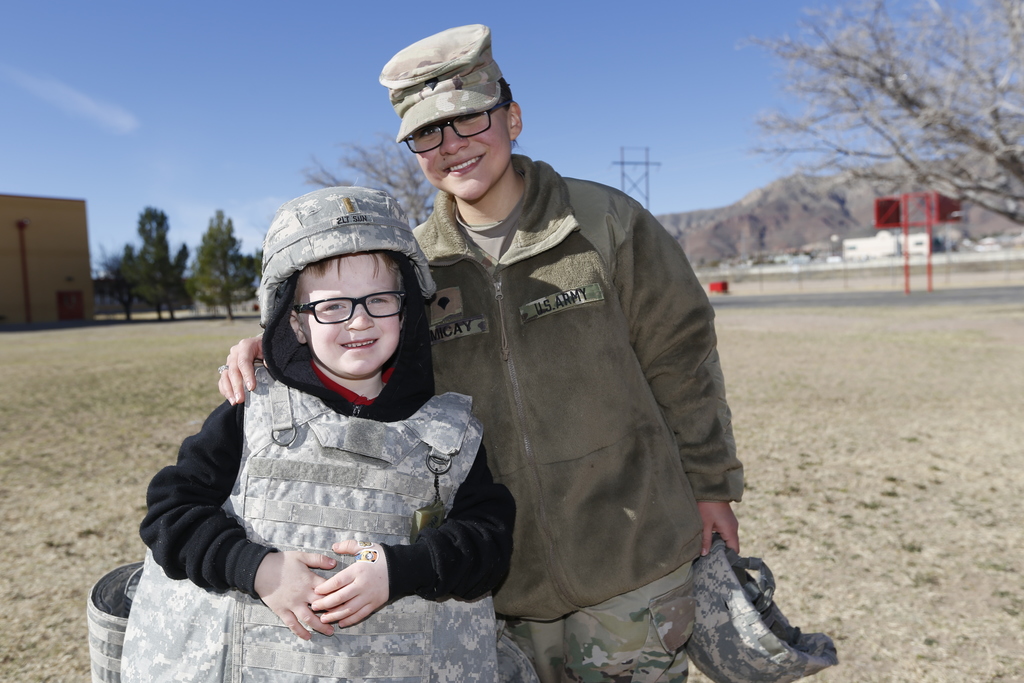 Military mom and her son smiling for a photo