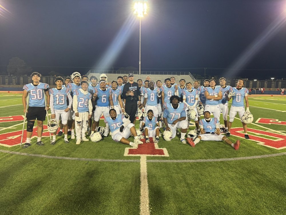 Group photo of Irvin football team with Jonathan Elliott, Head Football Coach at Irvin High School