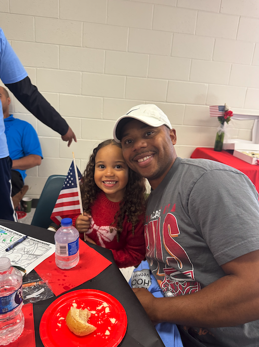 Daughter and father smile for a photo