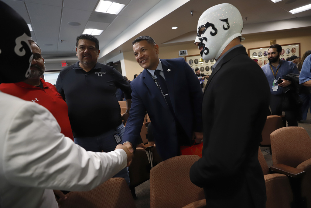 Jefferson High School Principal Edgar Rincon shakes community members hands