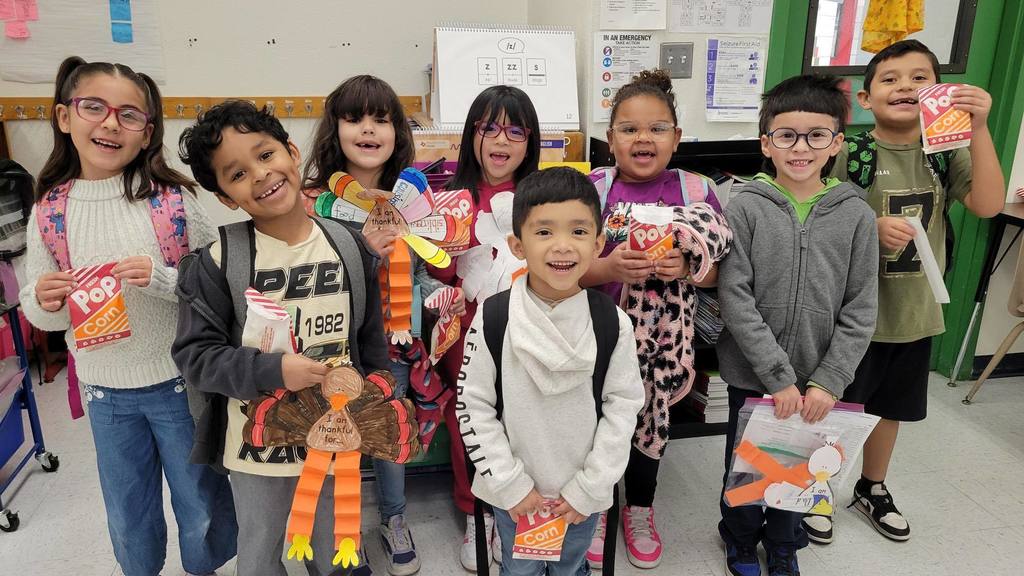 Whitaker Elementary students pose with their popcorn they earned for perfect attendance