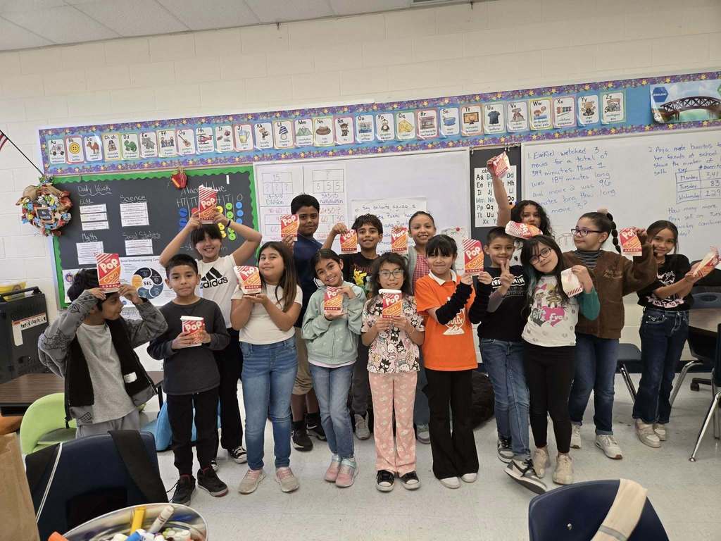 Whitaker Elementary students pose with their popcorn they earned for perfect attendance