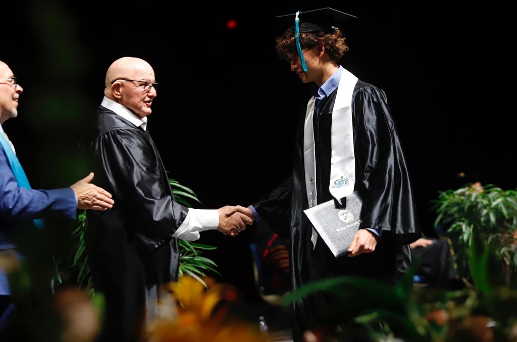 Transmountain Early College High School students shaking hands with EPCC staff after receiving diploma