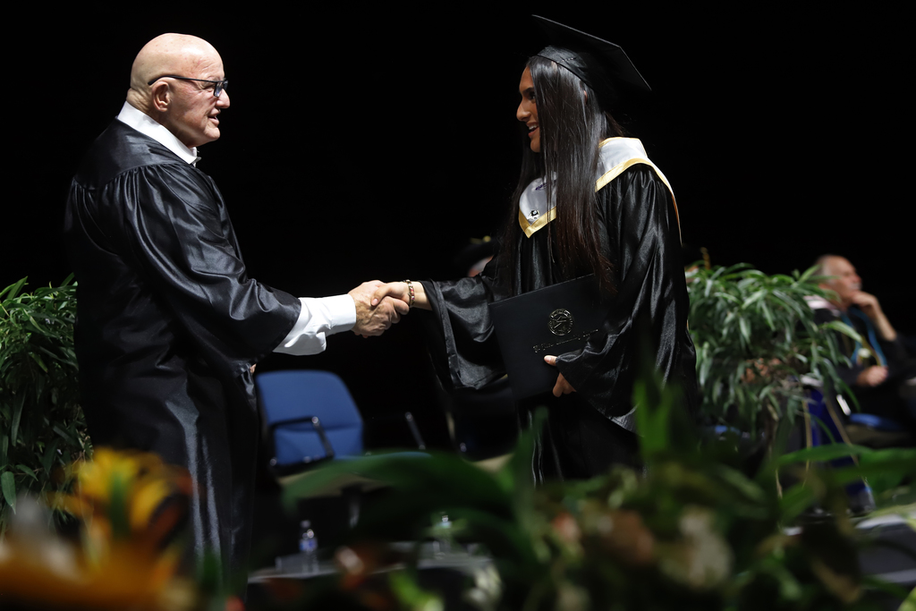 Franklin student shakes hand after receiving diploma
