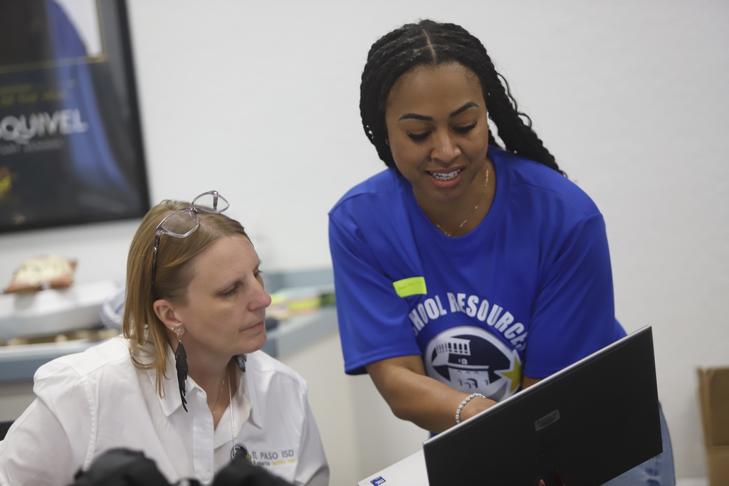 Two El Paso ISD employees looking at a laptop