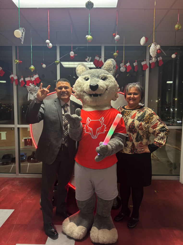 Jefferson Silva HS principal Edgar Rincon and EPISD staff member Marta Carmona take photo with Jefferson Silva mascot