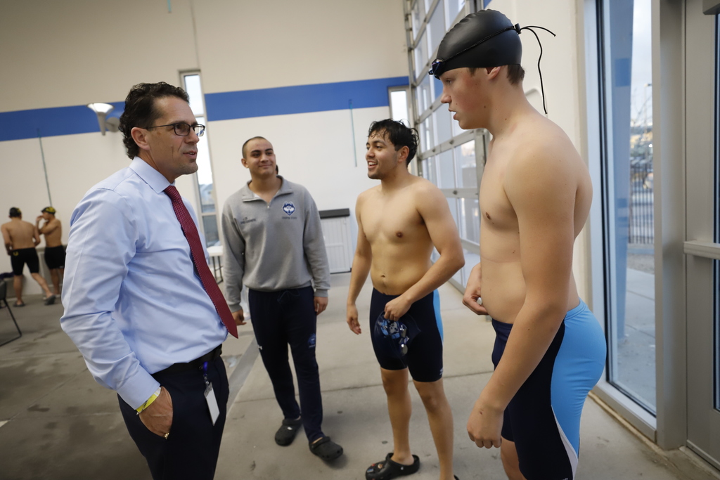 Chapin High School swimmers talking with Superintendent Dr. Brian Lusk