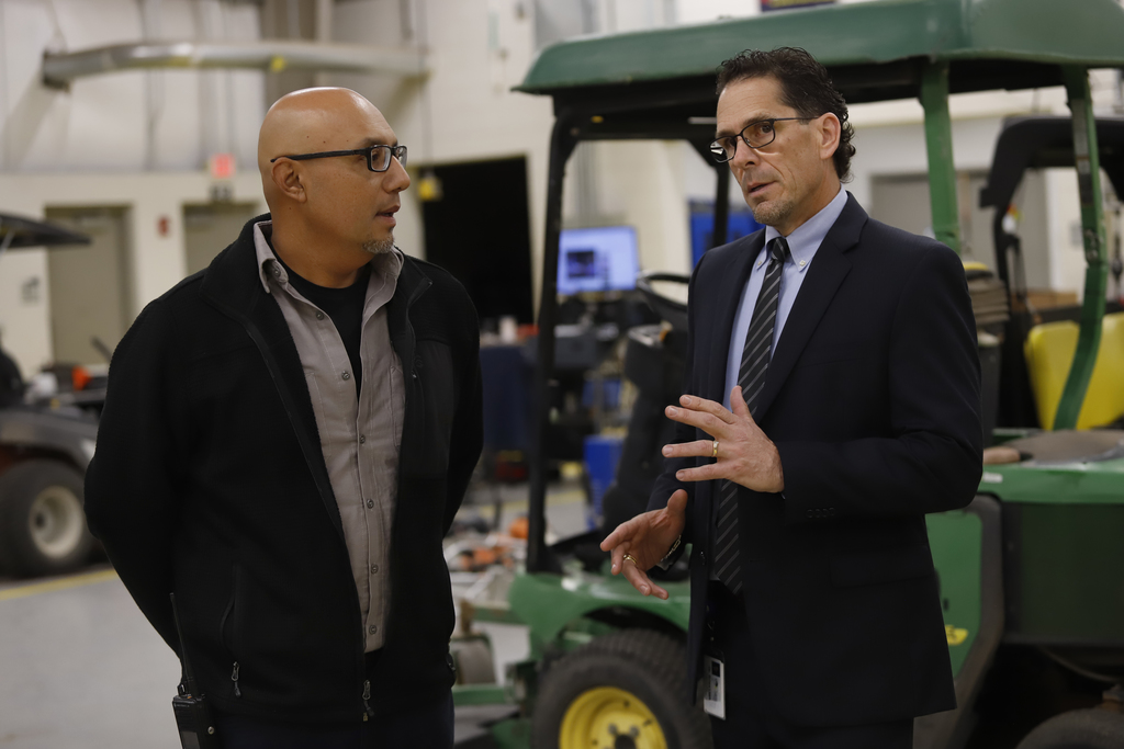 Superintendent Dr. Brian Lusk speaks to an employee