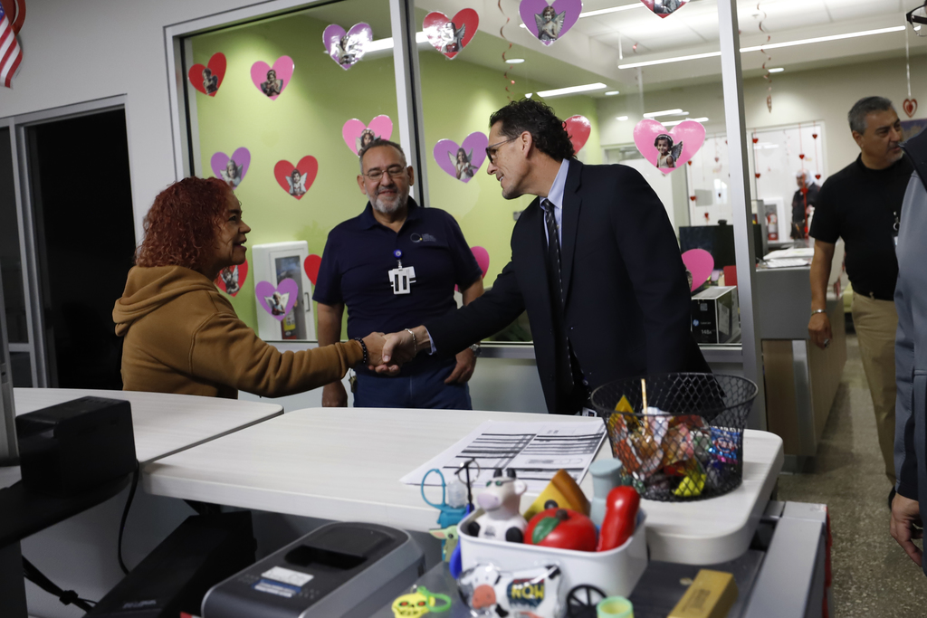 Superintendent Dr. Brian Lusk shakes hand with employee