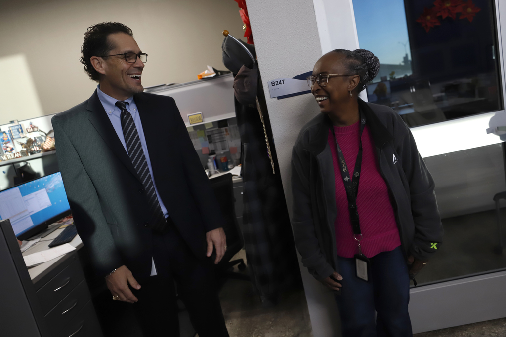 Superintendent Dr. Brian Lusk laughs with an employee