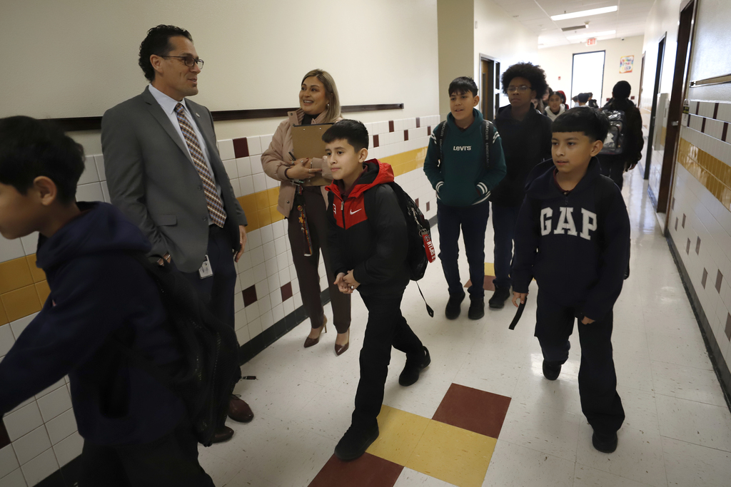 Superintendent Dr. Brian Lusk in hallway with Canyon Hills Middle School principal while students are walking to class