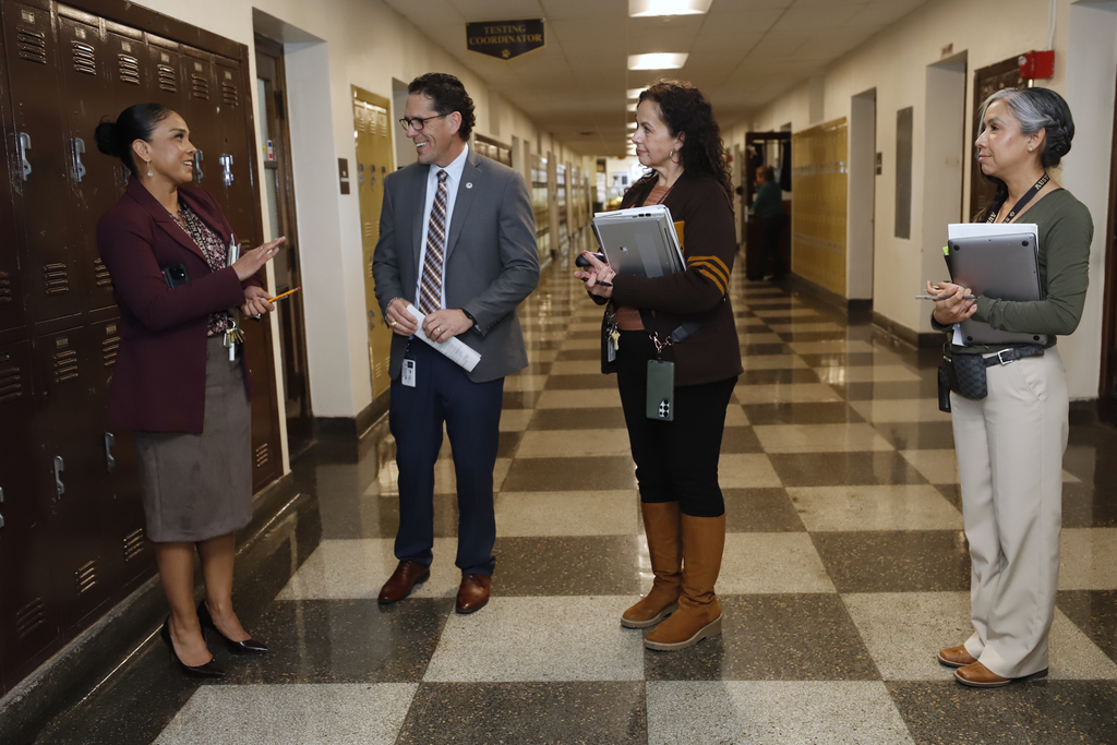 Superintendent Dr. Brian Lusk talking with Austin High School principal and staff