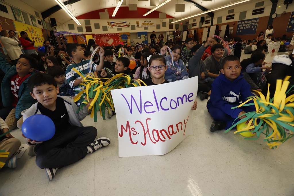Lamar Elementary School students hold a welcome sign El Paso ISD Board President Leah Hanany
