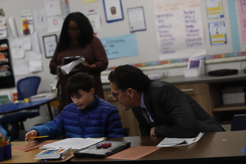 Superintendent Dr. Brian Lusk working with a student at Murphree PK-8