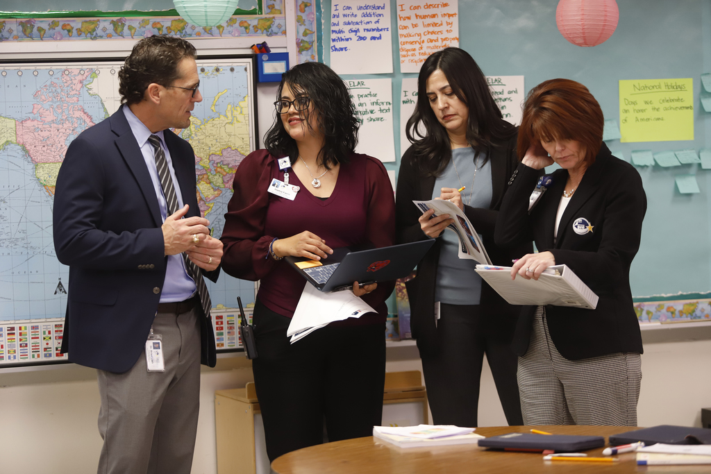 Zach White Elementary School staff and Superintendent Dr. Brian Lusk talking to one another