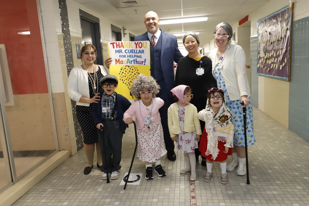 Trustee Alex Cuellar takes group photo with MacArthur PK8 Staff and students who are dressed up for the 100th day of school