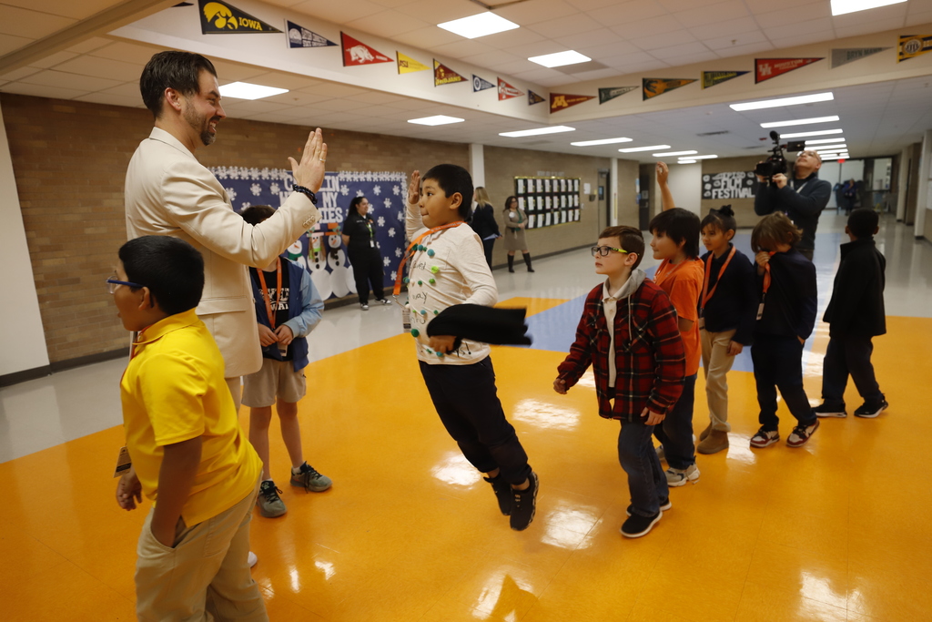 Trustee Daniel Call high fives a student