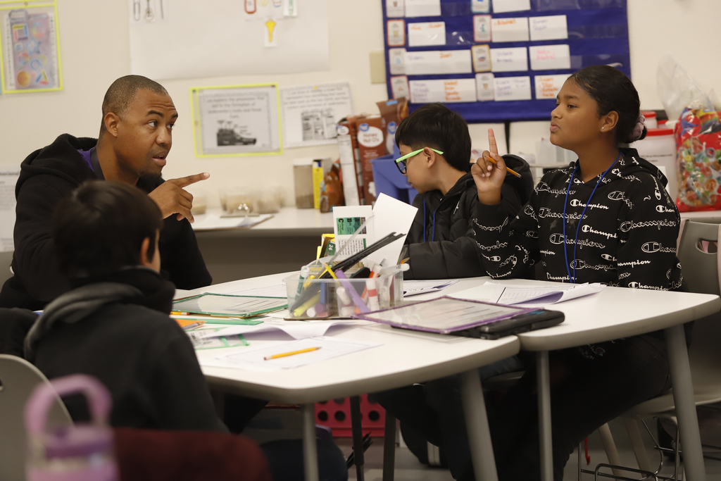 Teacher discussing class assignment with student