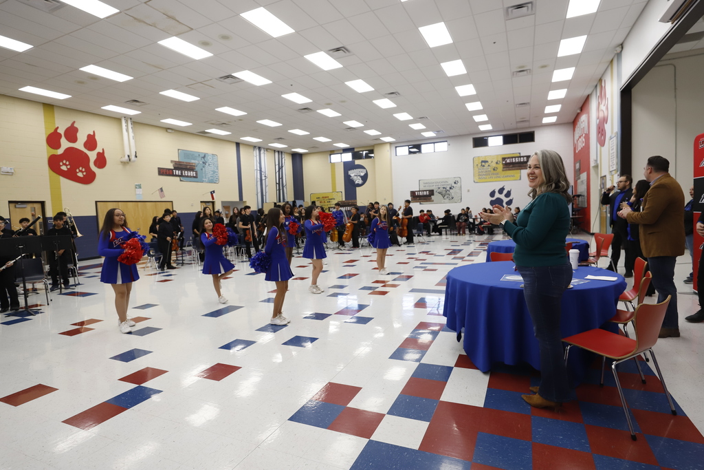 Magoffin Middle School cheerleaders and band performing for Trustee Mindy Sutton