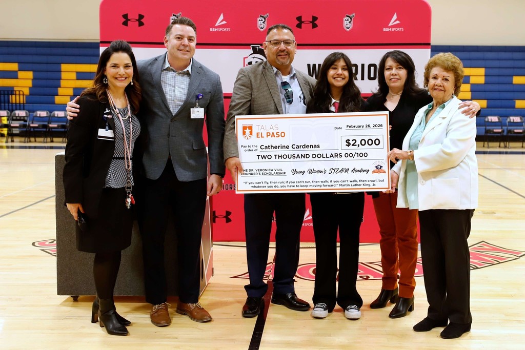 Young Women's Academy TALAS Recipient takes group photo with giant scholarship check