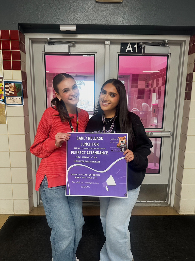 Franklin students smile for a photo with perfect attendance sign