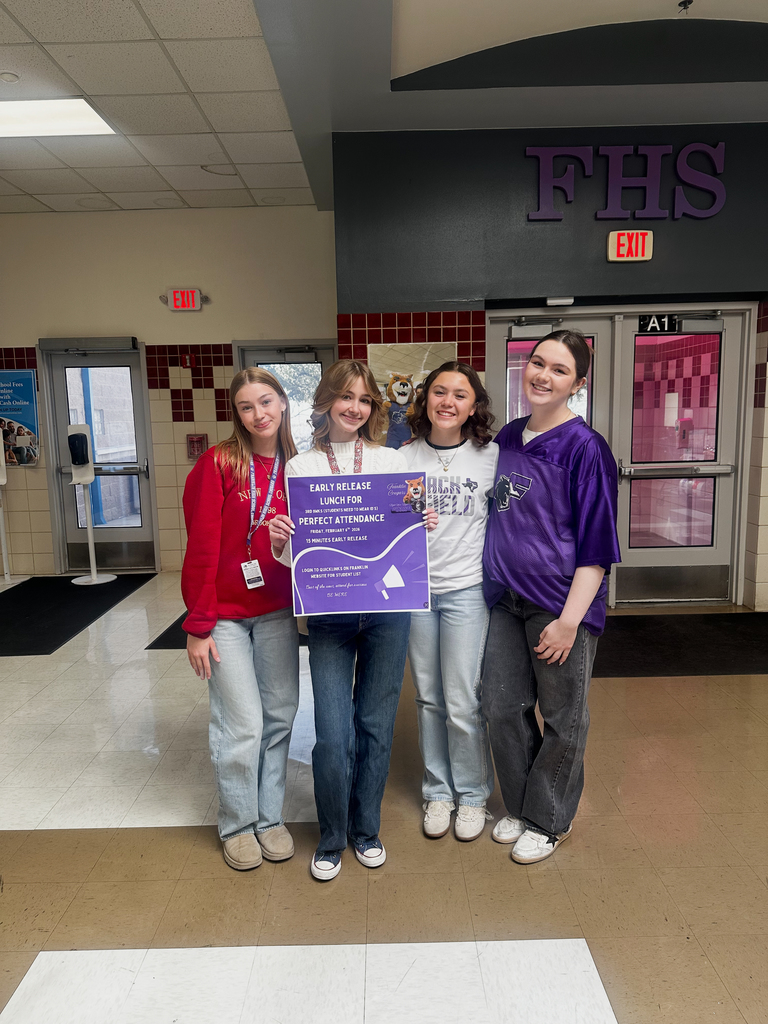 Franklin students smile for a photo with perfect attendance sign
