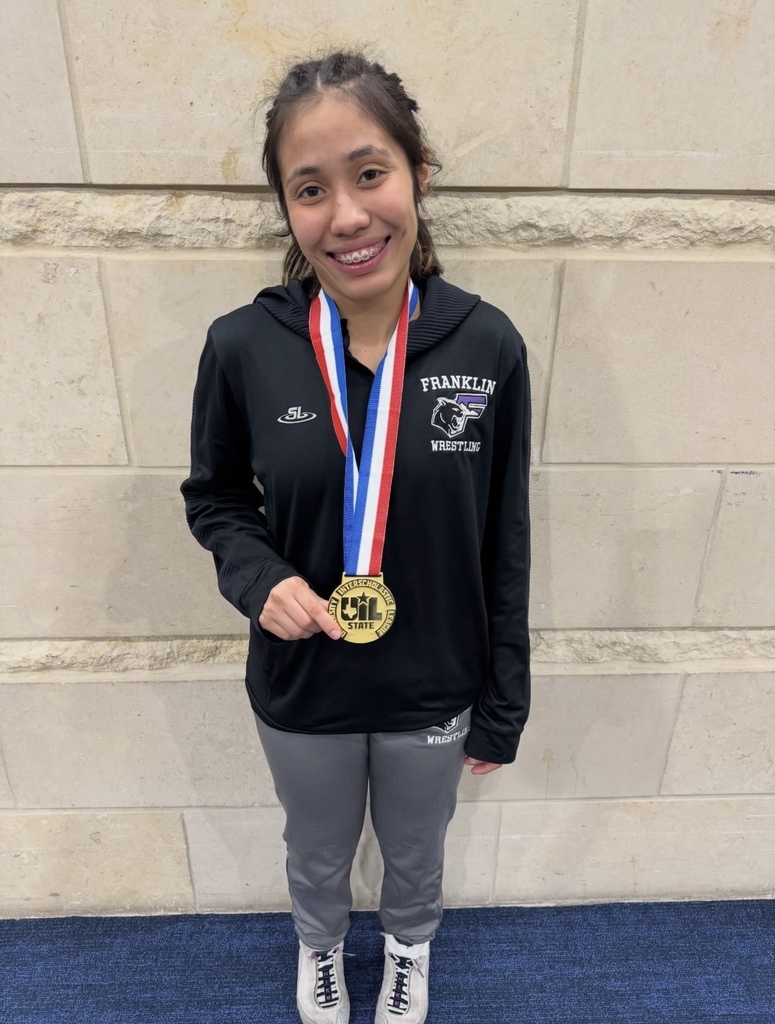 Franklin High School Senior Jubilee Rendon smiles for a photo with her Wrestling State Champion UIL medal