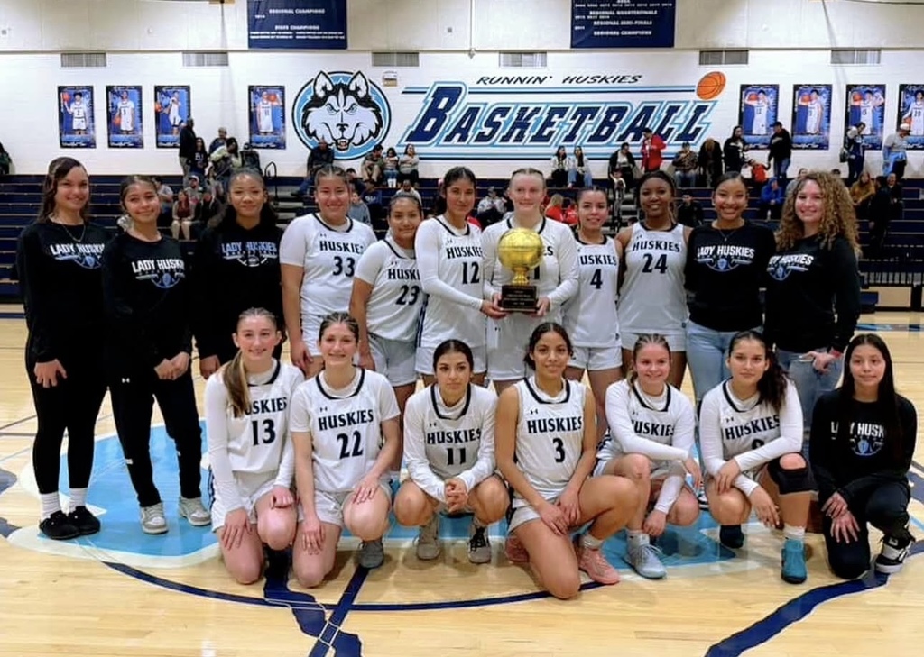 Photo of Chapin High School girls basketball team with their bi-district champions trophy