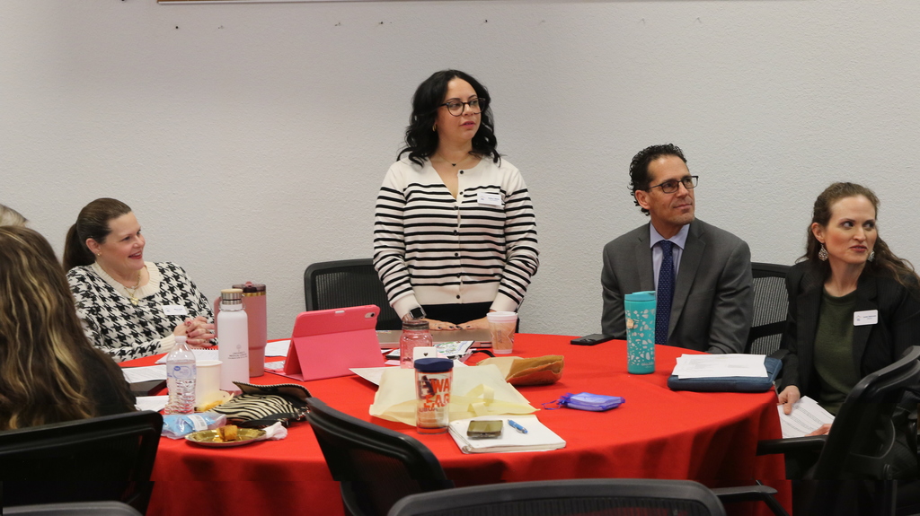 Superintendent Dr. Brian Lusk sitting with El Paso ISD Council of PTAs volunteers listening to presentations
