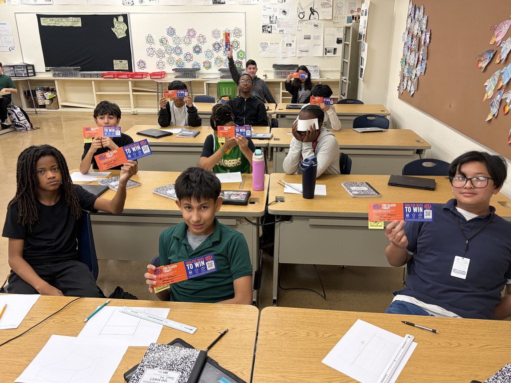 Charles Middle School students take a group photo with their Dave and Busters certificates