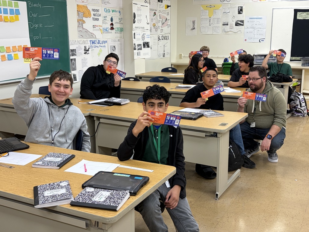 Charles Middle School students take a group photo with their Dave and Busters certificates
