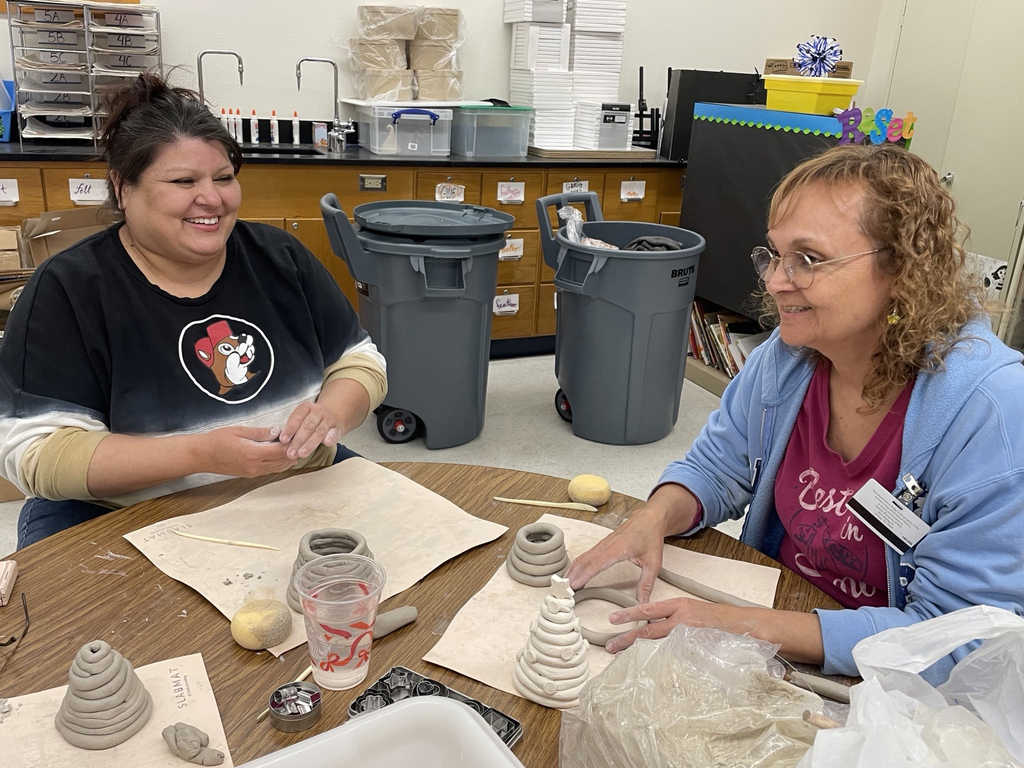 Photo of Healthy Living participants laughing while in pottery class