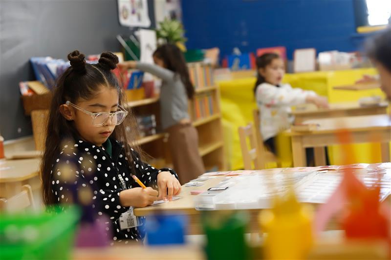 Montessori student in class working