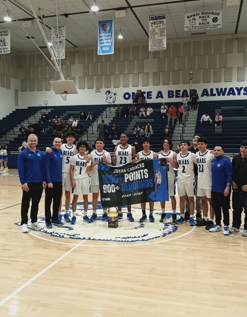 Bowie boys basketball team takes group photo with bi-district trophy