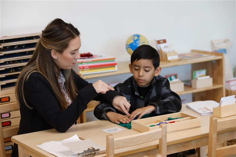 Montessori guide helping student