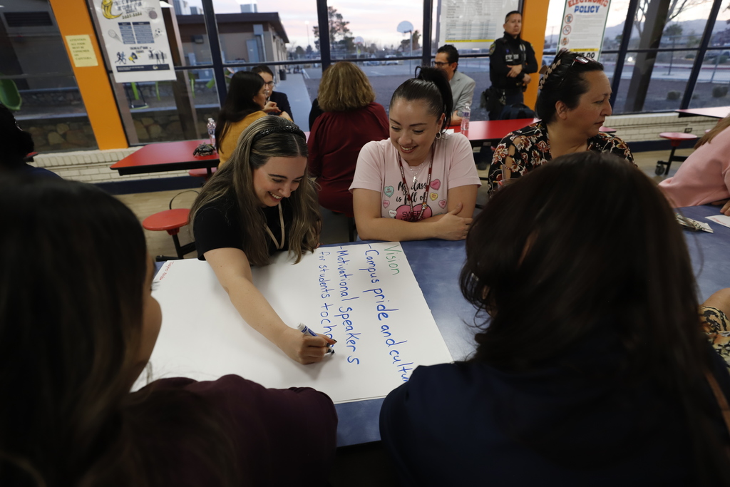 Tinajero community writing on poster during community conversations meeting