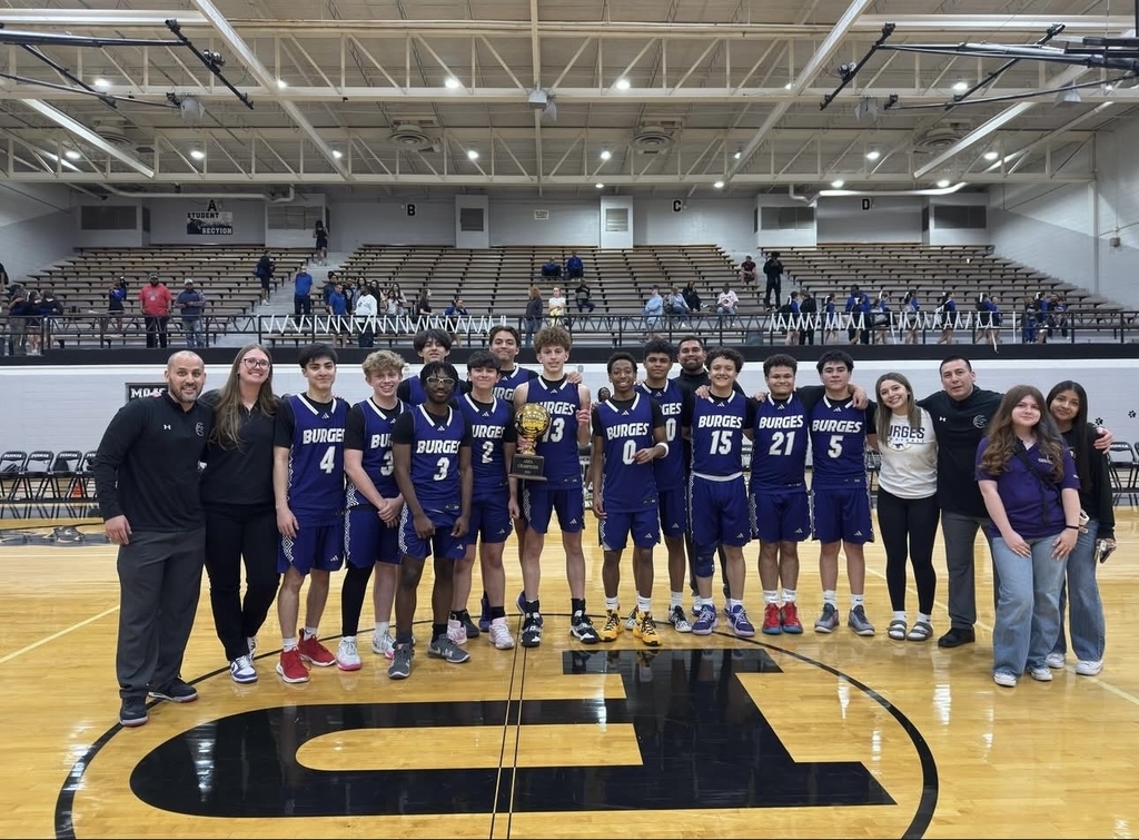 Photo of Burges High School boys basketball team taking group photo with their area champions trophy