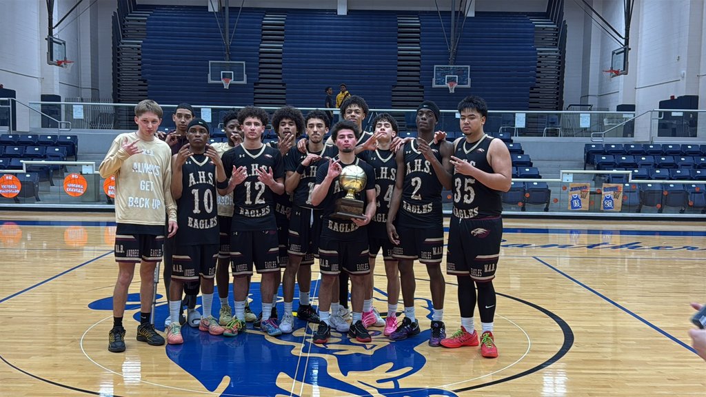 Andress High School boys basketball team takes a group photo with their area trophy