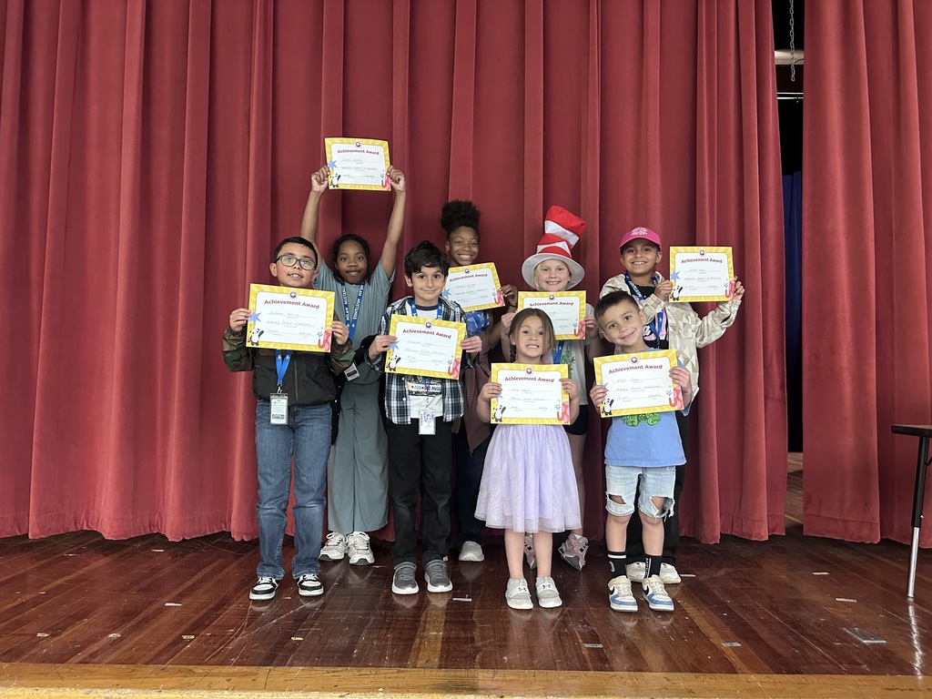 Eight Milam Elementary School students take a group photo with their Attendance Achievement Awards