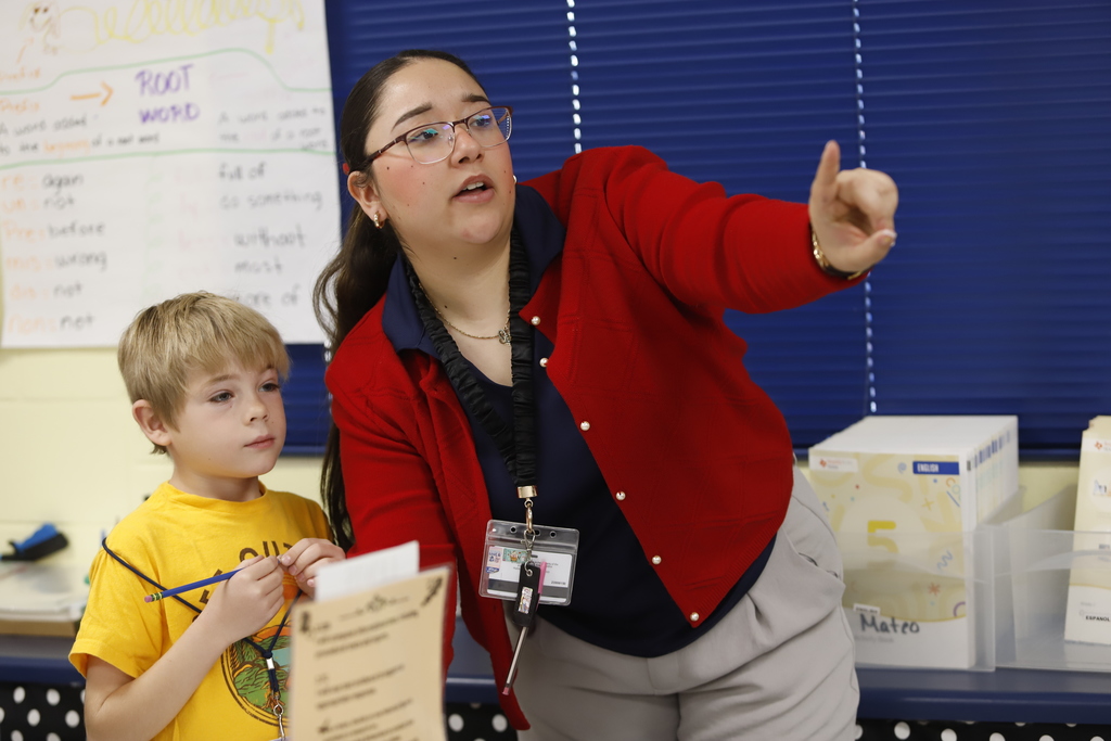 Teacher pointing to show student something