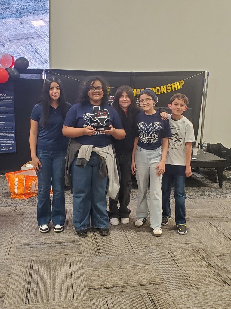 Guillen Middle School Robotics team takes a group photo with trophy