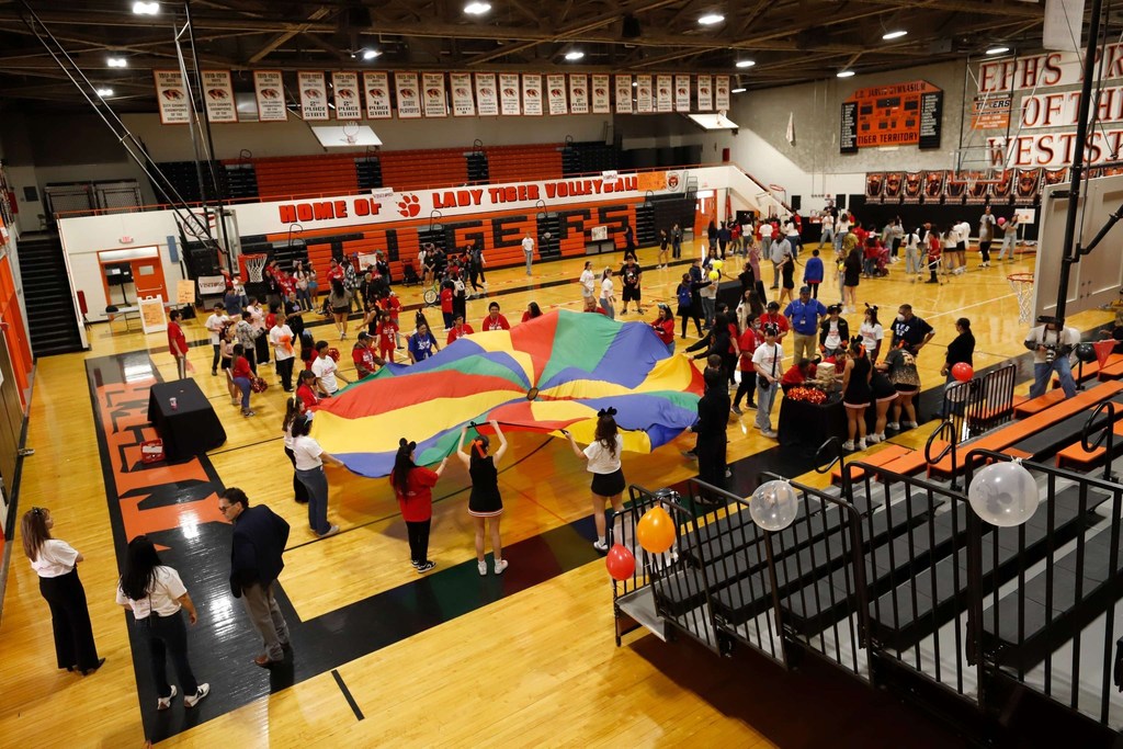 Overall shot of students participating in various activities at Tiger Palooza in the gym