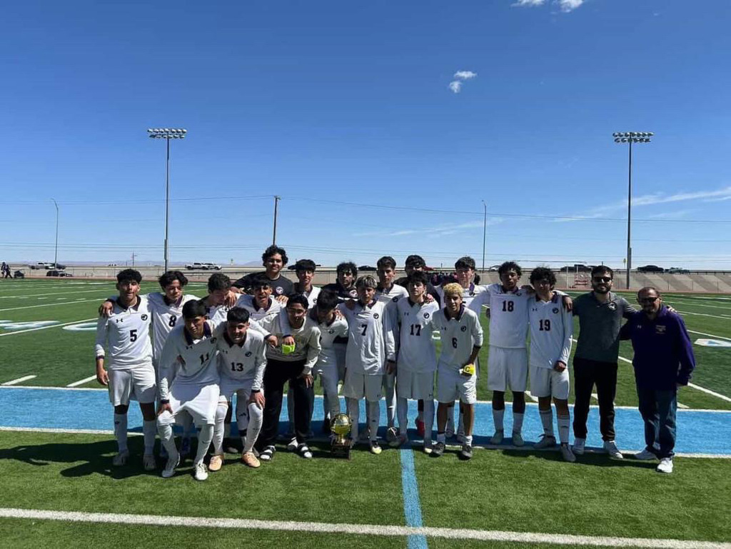 Burges High School Boys Soccer Team takes group photo with their District Champions Trophy