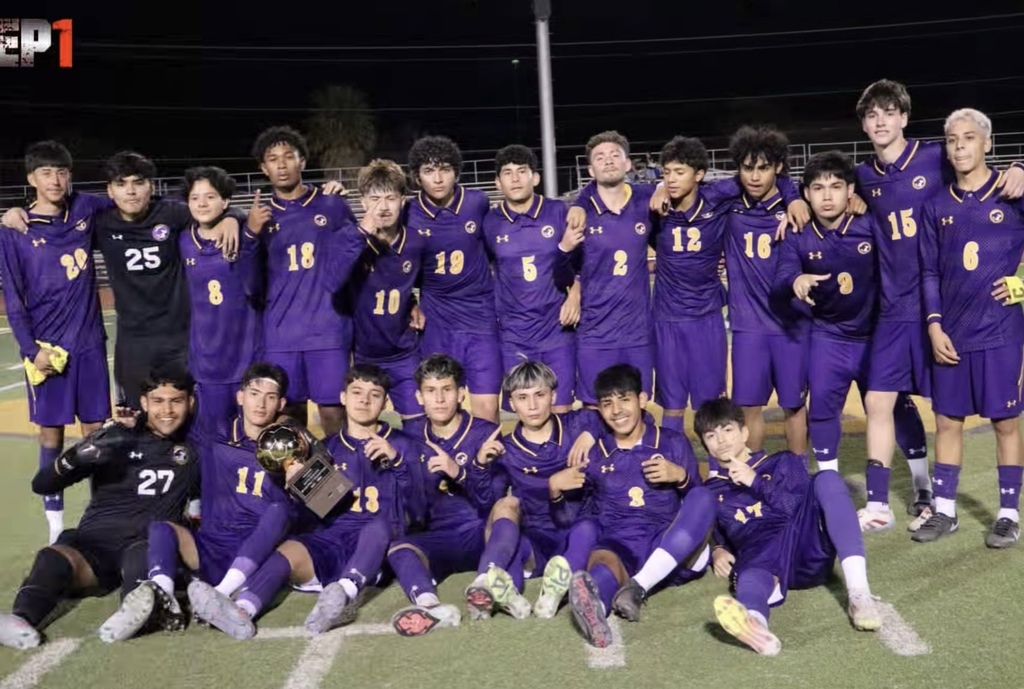 Group photo of the Burges High School Boys Soccer team with their Bi-District Champions Trophy