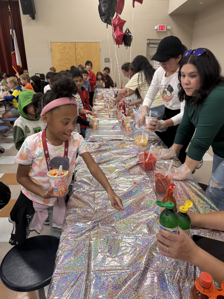Student smiles while reaching for lime juice
