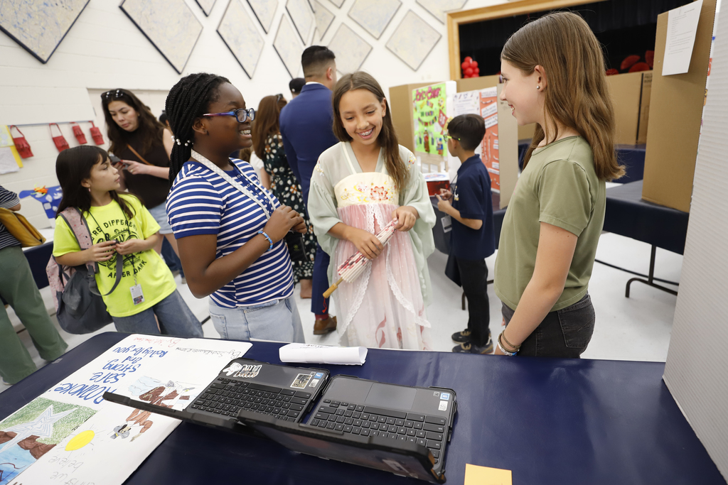 Mesita students smiling and talking at the Gifted & Talented Student Showcase