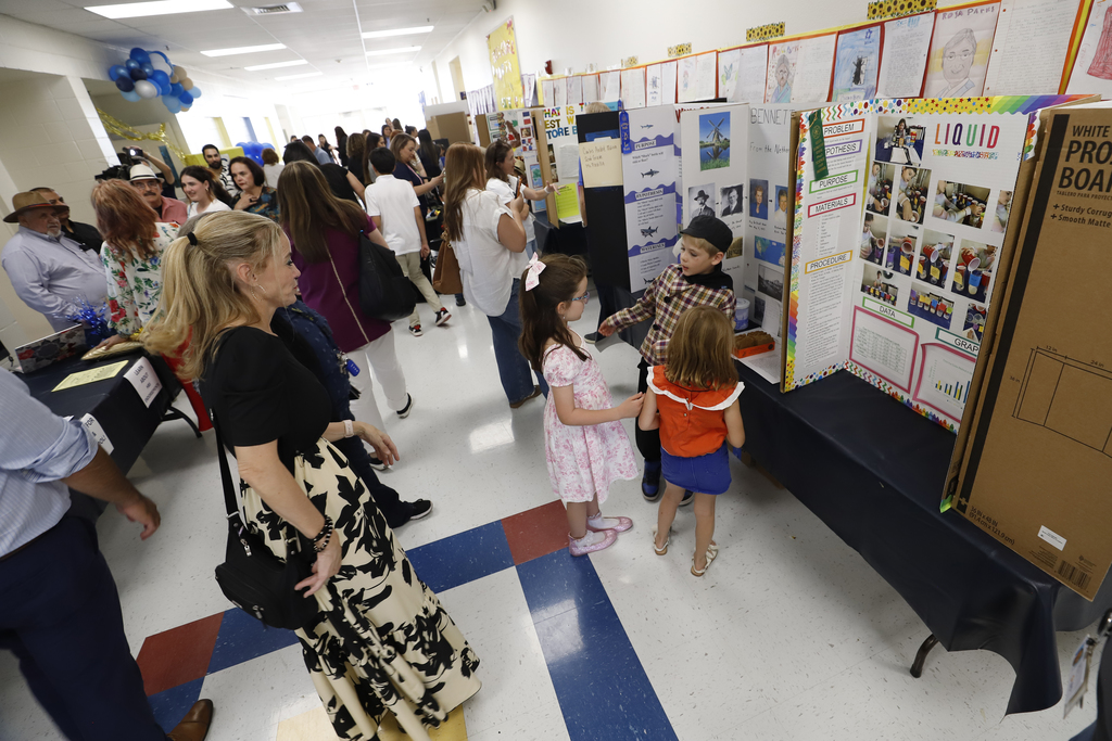 Photo of students presenting science fair projects at the Gifted & Talented Student Showcase