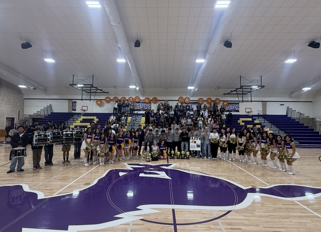 Group photo of Burges High School cheerleaders, boys soccer team, drumline and students and staff smiling for a photo during the send off celebration for the boys soccer team