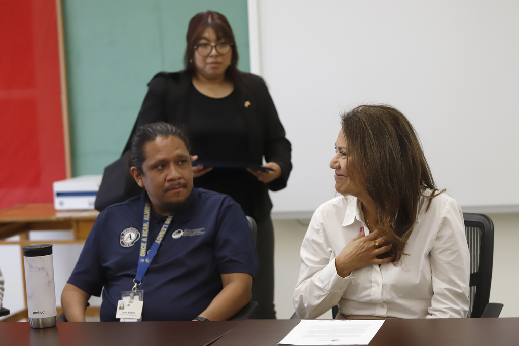 Congresswoman Veronica Escobar smiles holding hand on heart while talk to  El Paso ISD Community Schools program staff and other El Paso ISD staff members