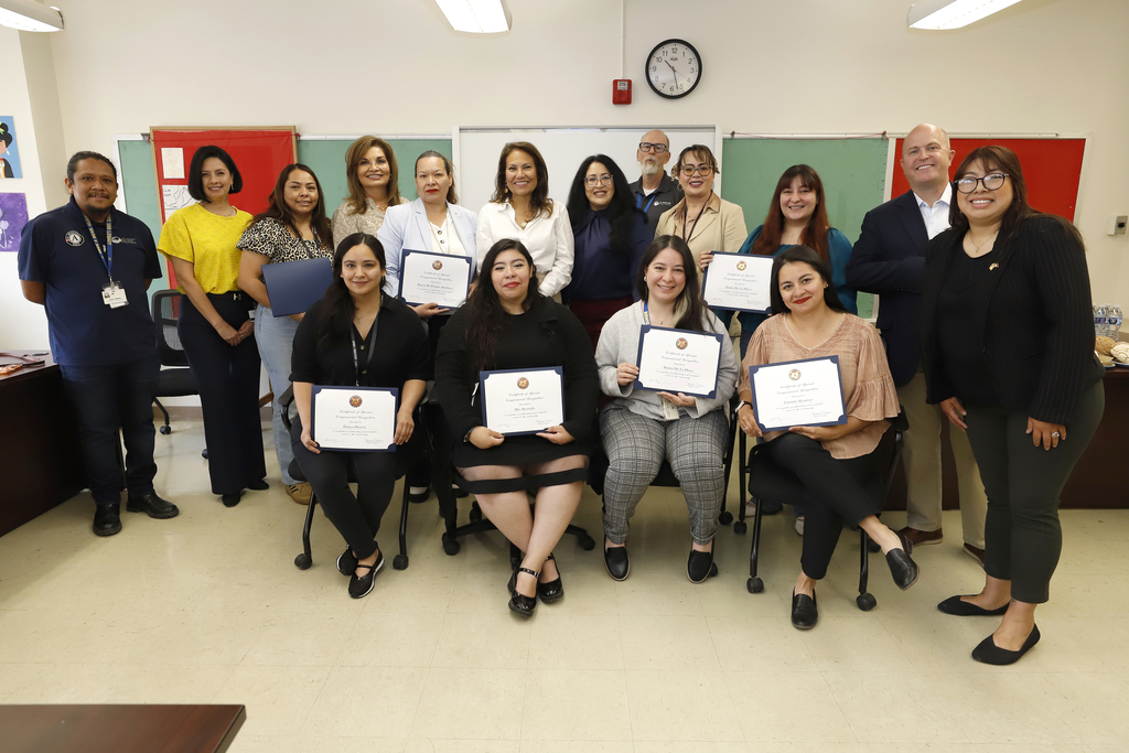 Congresswoman Veronica Escobar, El Paso ISD Community Schools program staff and other El Paso ISD staff members take group photo with certificates Escobar gave them for  National Service Recognition Day
